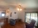 Cozy living room featuring wood laminate flooring and sliding glass doors to the enclosed porch at 1710 7Th Sw St # 39, Ruskin, FL 33570