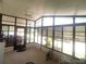 Enclosed porch with neutral carpet and views of the driveway and well-maintained landscaping at 1710 7Th Sw St # 39, Ruskin, FL 33570