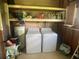 Utility room with a washer, dryer, and shelving for storage, making laundry tasks convenient and organized at 1710 7Th Sw St # 39, Ruskin, FL 33570