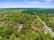 An aerial image showing a beautiful home surrounded by lush greenery, showcasing a desirable neighborhood at 17207 Bosley Dr, Spring Hill, FL 34610