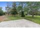 Spacious backyard featuring a concrete pad and mature trees at 17207 Bosley Dr, Spring Hill, FL 34610