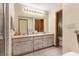 Bathroom featuring a double vanity with a large mirror and adjacent toilet and shower at 17207 Bosley Dr, Spring Hill, FL 34610