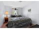 Bedroom featuring a comfortable bed with a nightstand, lamp, and window for natural light at 17207 Bosley Dr, Spring Hill, FL 34610