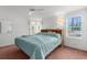 Bright bedroom featuring a ceiling fan, two windows for natural light and cozy carpet at 17207 Bosley Dr, Spring Hill, FL 34610
