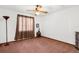 This bedroom features neutral walls, carpet, and a ceiling fan at 17207 Bosley Dr, Spring Hill, FL 34610