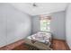 Comfortable bedroom with a cozy bed, window providing natural light and plush carpet at 17207 Bosley Dr, Spring Hill, FL 34610