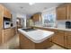Spacious kitchen featuring an island cooktop, ample cabinet space, and white appliances at 17207 Bosley Dr, Spring Hill, FL 34610