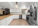 Spacious kitchen with white cabinetry, stainless steel appliances, and a tile floor at 17207 Bosley Dr, Spring Hill, FL 34610