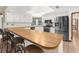 Bright kitchen featuring stainless steel appliances, a breakfast bar, and tile flooring at 17207 Bosley Dr, Spring Hill, FL 34610