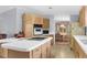 Open kitchen layout with white countertops, oak cabinets, and adjacent dining area at 17207 Bosley Dr, Spring Hill, FL 34610