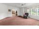 Carpeted living room offering natural light with a view into other rooms at 17207 Bosley Dr, Spring Hill, FL 34610
