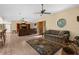 Open living space with tile flooring, a large entertainment center and a unique window at 17207 Bosley Dr, Spring Hill, FL 34610