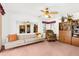 Carpeted living room with a mirror, sofa, and cabinets at 17207 Bosley Dr, Spring Hill, FL 34610