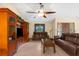 Comfortable living room with tile flooring, media center, and a ceiling fan at 17207 Bosley Dr, Spring Hill, FL 34610