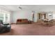 Open-concept living room and dining area with carpeting and lots of space at 17207 Bosley Dr, Spring Hill, FL 34610