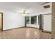 Empty living room with tile floor, bay window and ceiling fan at 17207 Bosley Dr, Spring Hill, FL 34610