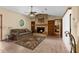 Cozy living room with a stone fireplace, built-in bookshelves, and a ceiling fan at 17207 Bosley Dr, Spring Hill, FL 34610