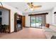 Living room with carpet, sliding glass doors, and a bookcase at 17207 Bosley Dr, Spring Hill, FL 34610