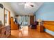Bedroom with hard wood floors, a desk, chair and door to an exterior pool area at 17207 Bosley Dr, Spring Hill, FL 34610