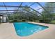 A clear in-ground pool with a screened enclosure at 17207 Bosley Dr, Spring Hill, FL 34610