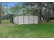 Exterior view of backyard storage shed with double doors at 17207 Bosley Dr, Spring Hill, FL 34610