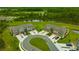 Aerial view of a community of townhomes with lush landscaping and nearby pond at 17741 Tawny Malt Pl, Land O Lakes, FL 34638