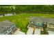 Aerial view of the townhome community with large green spaces and a pond in the background at 17741 Tawny Malt Pl, Land O Lakes, FL 34638