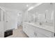 Modern bathroom featuring a double sink vanity, a large mirror, and a walk-in shower at 17741 Tawny Malt Pl, Land O Lakes, FL 34638