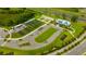 Aerial view showcasing the garden, parking, and community center, highlighting amenities and landscaping at 17741 Tawny Malt Pl, Land O Lakes, FL 34638