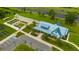 Aerial view of a community center with well-manicured landscaping, parking, and a nearby garden at 17741 Tawny Malt Pl, Land O Lakes, FL 34638