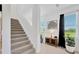 Welcoming entryway with staircase, neutral tones, stylish decor, and plenty of natural light at 17741 Tawny Malt Pl, Land O Lakes, FL 34638