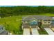 Aerial view of new construction townhomes with attached garages and well-manicured lawns at 17741 Tawny Malt Pl, Land O Lakes, FL 34638