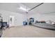 Spacious two car garage with clean flooring and plenty of extra storage space at 17741 Tawny Malt Pl, Land O Lakes, FL 34638