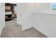 Upstairs hallway offering a view into the naturally lit main bedroom with a door leading into the hall at 17741 Tawny Malt Pl, Land O Lakes, FL 34638