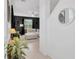 Hallway view showing a living room, tiled flooring, and neutral wall colors at 17741 Tawny Malt Pl, Land O Lakes, FL 34638