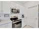 Clean kitchen with stainless steel appliances, white cabinets and countertops and modern lighting at 17741 Tawny Malt Pl, Land O Lakes, FL 34638