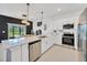 Contemporary kitchen with stainless steel appliances, quartz countertops, and an open layout at 17741 Tawny Malt Pl, Land O Lakes, FL 34638
