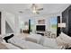 Spacious living room featuring a large sectional, staircase and abundant natural light at 17741 Tawny Malt Pl, Land O Lakes, FL 34638