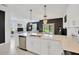 Open-concept living space with modern kitchen, dining area, and comfortable seating area at 17741 Tawny Malt Pl, Land O Lakes, FL 34638