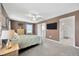 Cozy main bedroom featuring a ceiling fan, carpeted floor, and an attached ensuite bathroom at 17741 Tawny Malt Pl, Land O Lakes, FL 34638