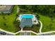 An aerial view of a community pool surrounded by palm trees and lounge chairs at 17741 Tawny Malt Pl, Land O Lakes, FL 34638
