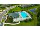 Aerial view of a pristine community pool with lounge chairs and lush landscaping in a desirable neighborhood at 17741 Tawny Malt Pl, Land O Lakes, FL 34638