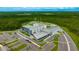 Aerial view of a modern school complex surrounded by lush greenery and parking facilities at 17741 Tawny Malt Pl, Land O Lakes, FL 34638