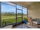 Relaxing screened porch with comfortable seating and peaceful views of the lush green landscape at 17741 Tawny Malt Pl, Land O Lakes, FL 34638