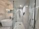 Elegant bathroom featuring a glass-enclosed shower, standalone tub, and luxurious finishes at 17926 Calkins Ct, Spring Hill, FL 34610