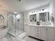 Elegant bathroom featuring a glass-enclosed shower, dual sink vanity, and luxurious soaking tub at 17926 Calkins Ct, Spring Hill, FL 34610