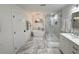 Elegant bathroom featuring a glass-enclosed shower, standalone tub, and luxurious finishes at 17926 Calkins Ct, Spring Hill, FL 34610