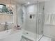Elegant bathroom featuring a glass-enclosed shower, standalone tub, and luxurious finishes at 17926 Calkins Ct, Spring Hill, FL 34610