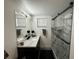 Modern bathroom features a large vanity with marble countertop and a glass enclosed shower with marble-style tiles at 17926 Calkins Ct, Spring Hill, FL 34610