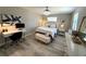 Bright bedroom featuring a chandelier, work space, light wood floors and decor at 17926 Calkins Ct, Spring Hill, FL 34610